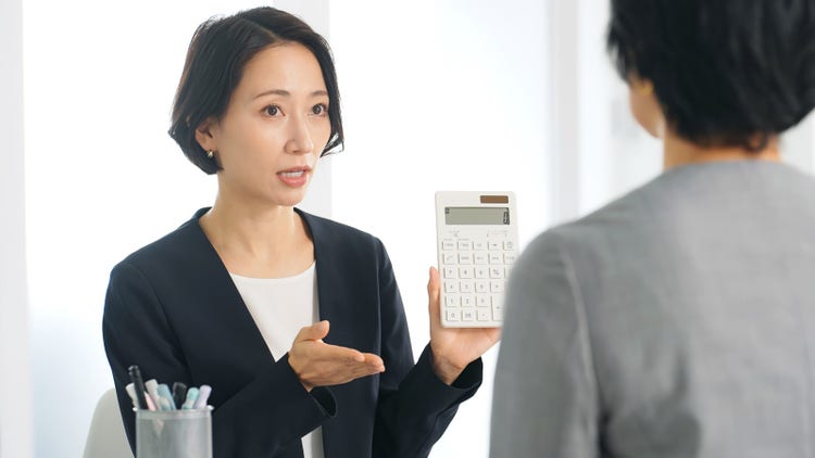 A lady offers a price to be entered into a calculator from another vendor.
