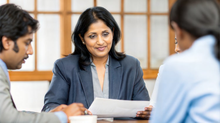 A team of businesspeople looking through and finalising a contract.
