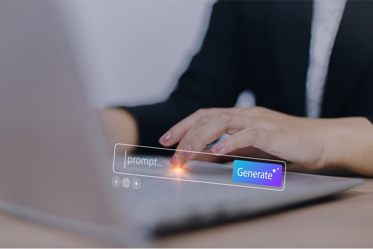 A woman using her computer to enter an AI prompt and generate content.