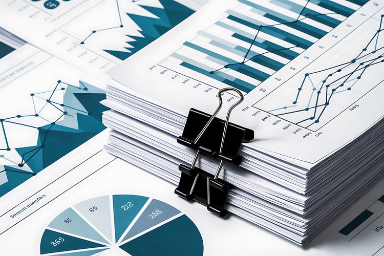A stack of reports displaying graphs, charts, and other data.