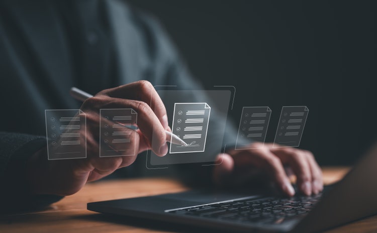 A businessman signing electronic documents in a digital file on a virtual screen.