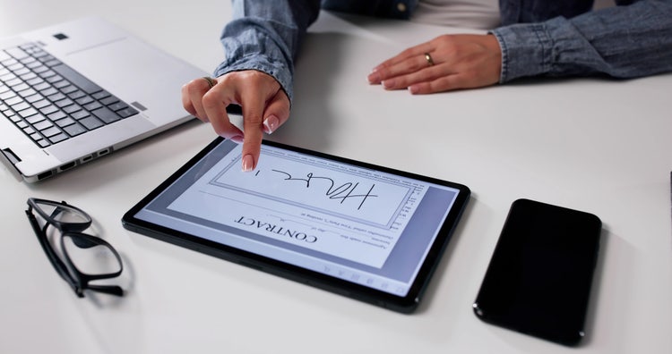 Signing customer contracts using digital signature on tablet.