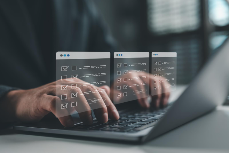 A person filling out digital forms and managing multiple documents on a laptop in preparation for a NOC application.