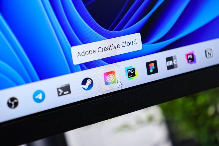 Adobe Creative Cloud app displayed on a computer screen, with a mouse cursor pointing at its icon.