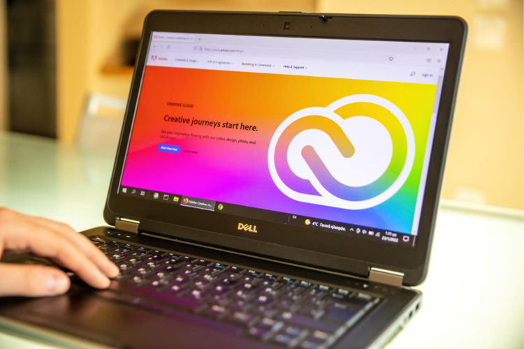 A laptop screen showing the landing page for the Adobe Creative Cloud website.