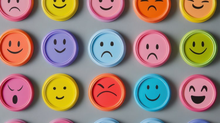 A vibrant collection of illustrated human faces on circular tokens, each expressing different emotions, symbolising the psychological impact of colours.