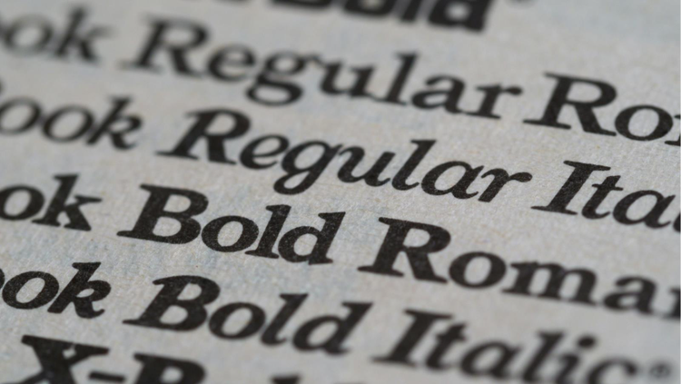 Graphic design typography sample showing bold, regular, and italic font styles on textured paper.