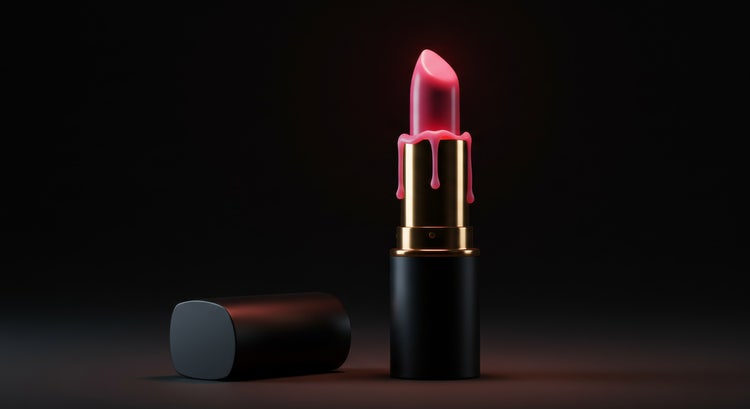 A professional photo taken of a pink lipstick with a dripping effect on a dark background.