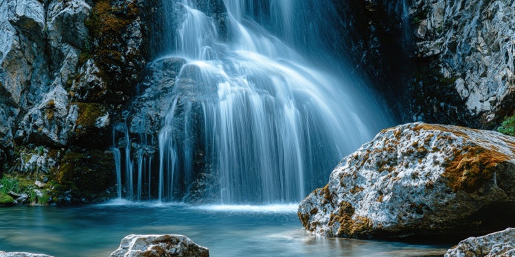 A long exposure photo of water cascading down a waterfall.