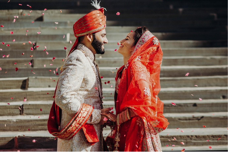 An Indian couple in traditional attire taking part in a wedding ceremony, capturing cultural rituals, vibrant colours and emotional moments.