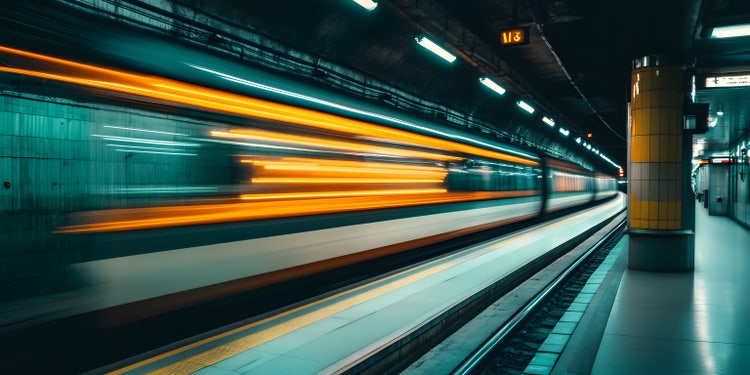 Speeding subway train captured with long exposure photography, showing colorful lights in an urban underground tunnel.