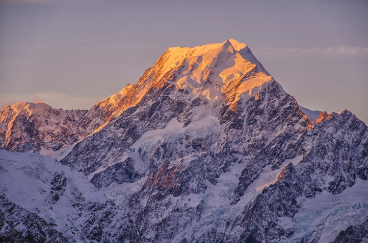 Peak mountain landscape photographed with depth of field, highlighting foreground and distant peaks.