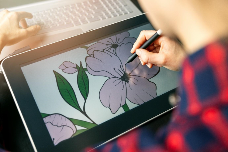 An illustrator drawing a flower on a tablet.
