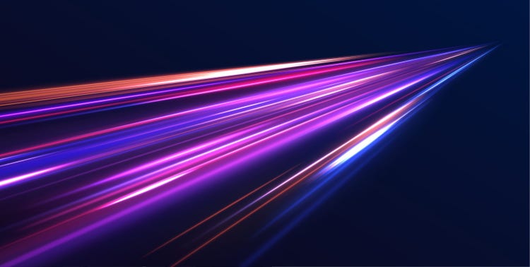 Long exposure, light painting photography of purple and orange lines against a black background.