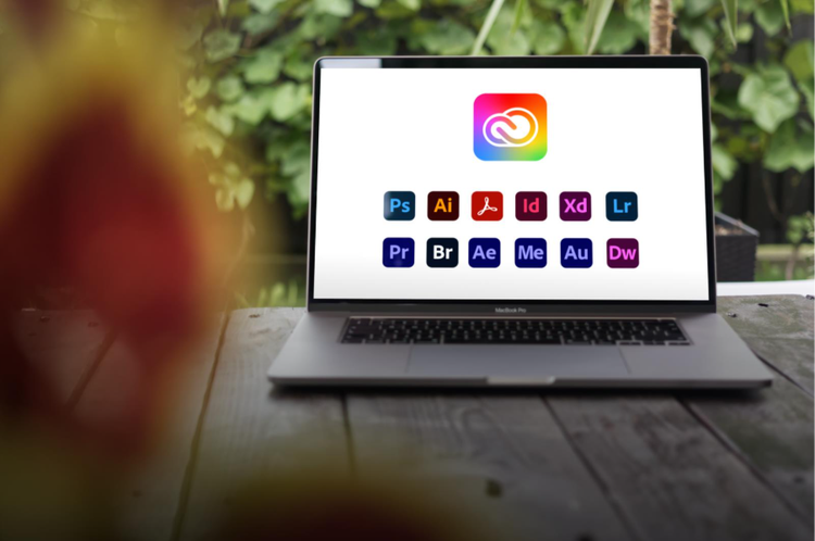 A laptop screen showing different Adobe Creative Cloud apps.