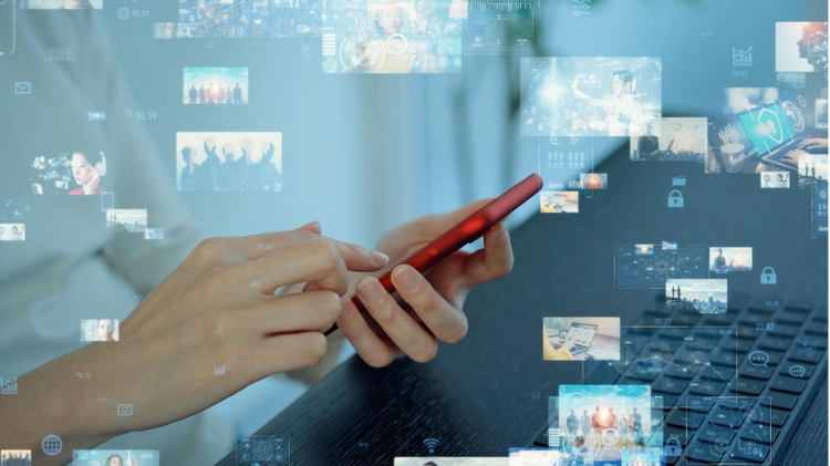 Close-up of a person using a smartphone with video content floating around them, representing frame rate optimisation and digital media playback.