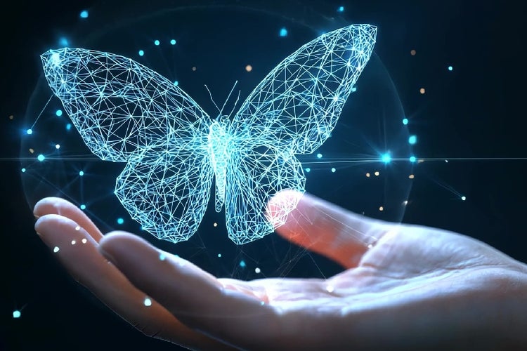 Futuristic AI concept video showing a human hand holding a glowing holographic butterfly made from digital low-poly wireframe elements against a dark background.