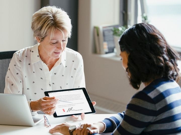 A doctor walking a patient through a privacy practices document before they sign it using Adobe Acrobat Sign