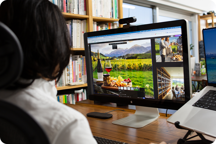 生成AIで制作したワインキャンペーン用ビジュアルをモニターで確認しながら、Webサイトのデザイン制作を進めている様子。