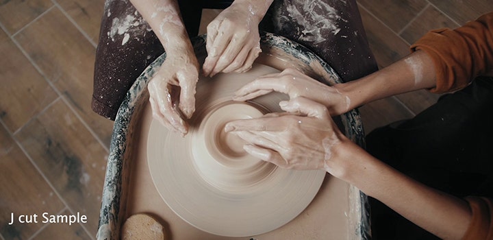 A J cut editing technique applied to a video footage of people working at a pottery wheel together