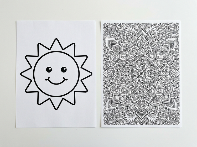 Two printed AI-generated coloring pages laid flat side by side on a clean white surface — a bold simple outline on the left and a detailed pattern on the right