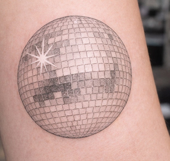 A photorealistic image of a disco ball on skin. UI in the upper left corner shows the generated reference image.
