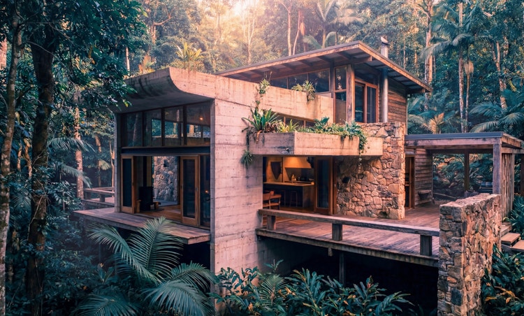 A postmodern architecture house in the middle of a jungle.
