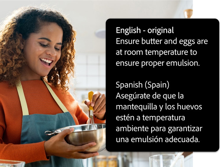 A woman whisking ingredients together in a kitchen. UI to the right says "English - original. Ensure butter and eggs are at room temperature to ensure proper emulsion," and "Spanish (Spain) Asegúrate de que la mantequilla y los huevos estén a temperatura ambiente para garantizar una emusión adecuada.