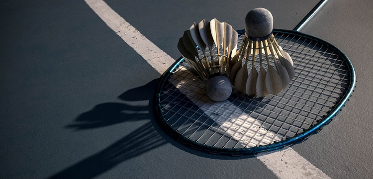 two 3D shuttlecocks sitting on badminton racket