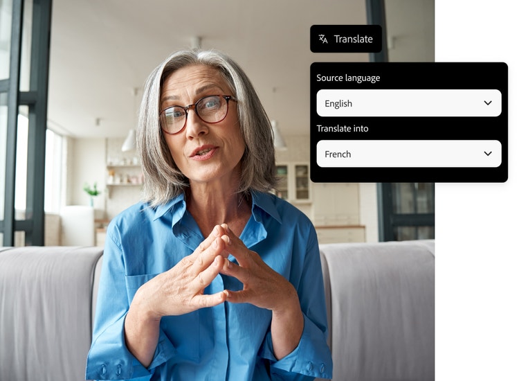 A woman in a blue shirt sits on a couch speaking to the camera with graphic overly of the AI translation tools English to French settings.