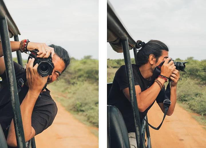 A wildlife photographer leaning out of an open-frame jeep and taking a photo of the person photographing them