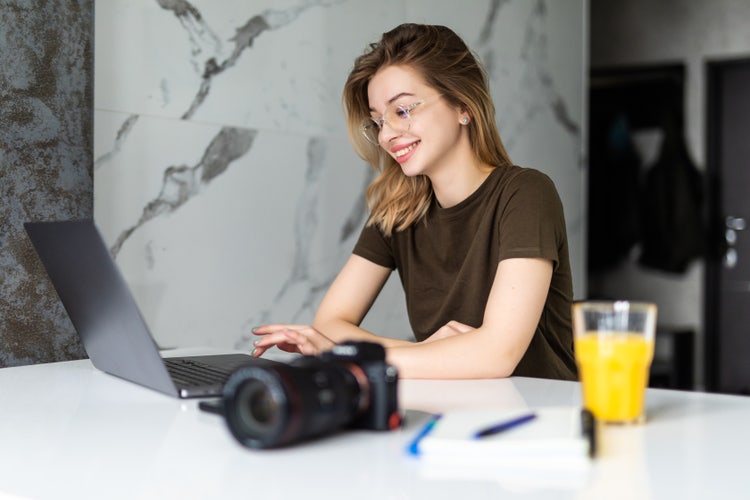 A photographer researches when you need a photo release form for consent on a laptop.