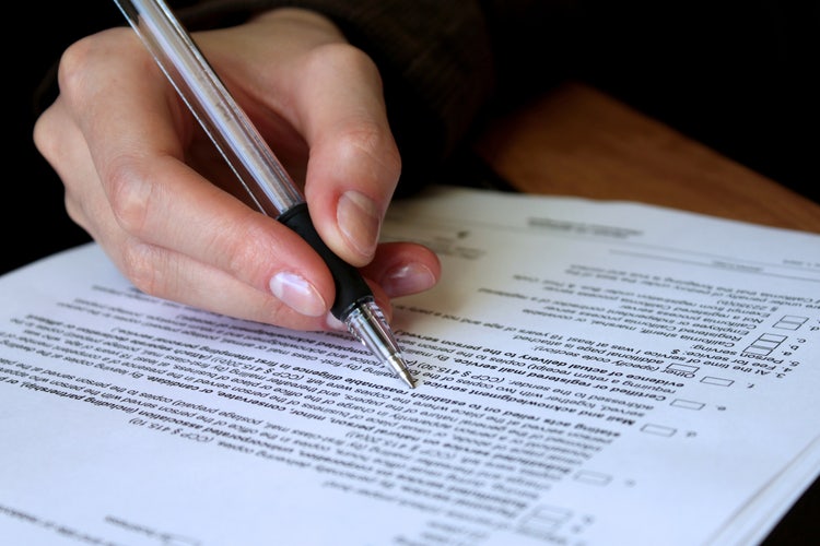 A person reviews and amends a business contract.