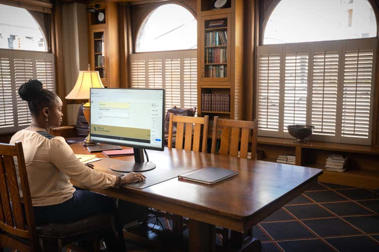 A woman uses a computer to look at the different types of legal documents.