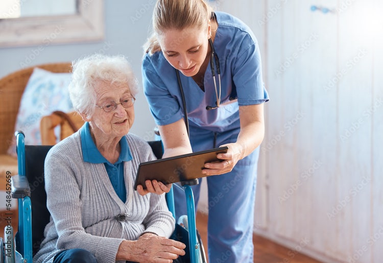 A nurse shows an elderly patient their ePCR on a tablet.