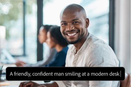 Photo of a smiling person seated at a modern desk, with a prompt label reading, “A friendly, confident man smiling at a modern desk.”