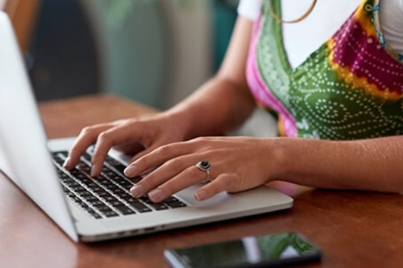 A close-up of a college student using their laptop