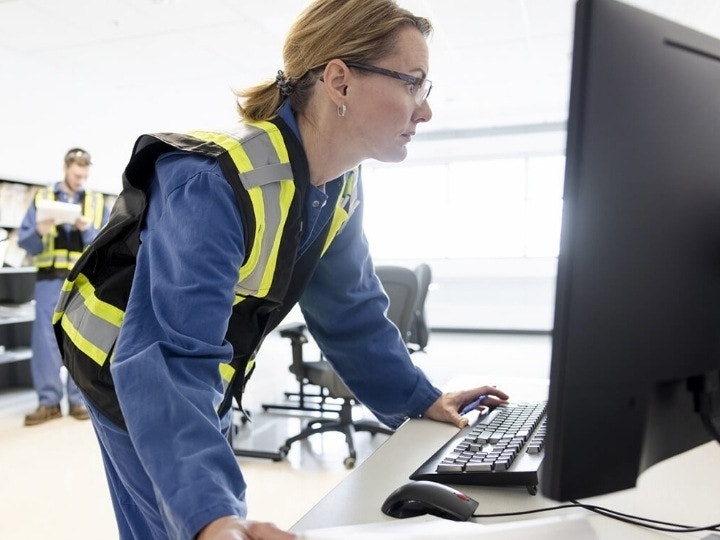 Safety personnel reviewing digital and physical documentation