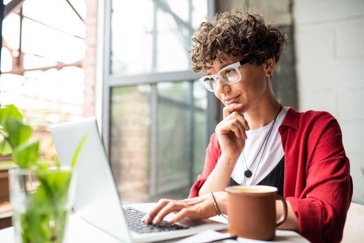 A woman saves and separates PDF pages in Adobe Acrobat.