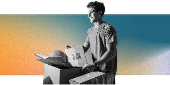 A man holds a box of packed items.