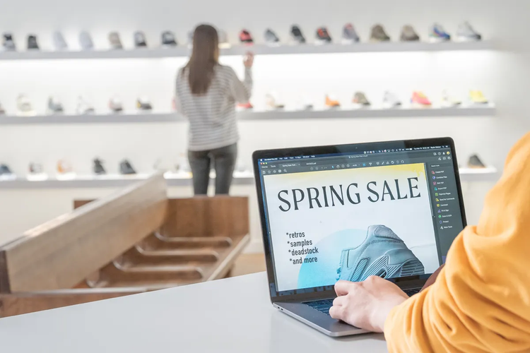 A person designing a Spring Sale flyer inside a show