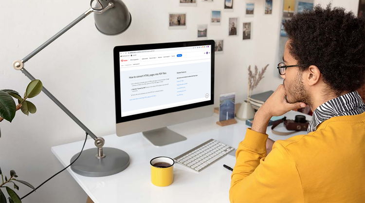 A person converting an HTML web page to PDF while sitting at their desk with a cup of coffee