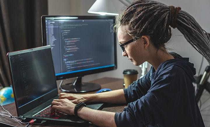 A young woman typing on a computer