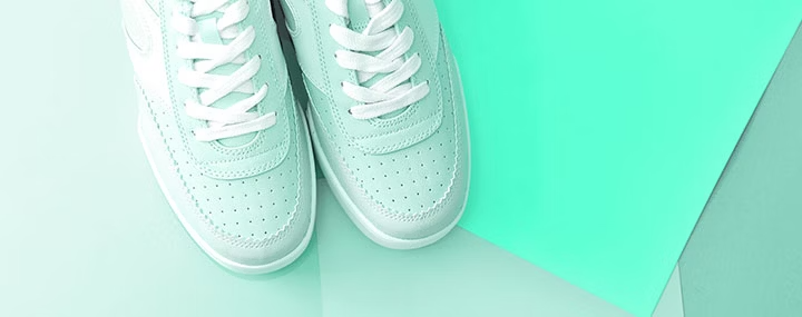 Pale green shoes on a light green background