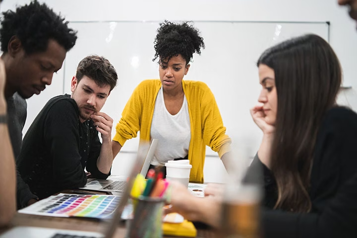 Group of people in an office looking at colour palettes