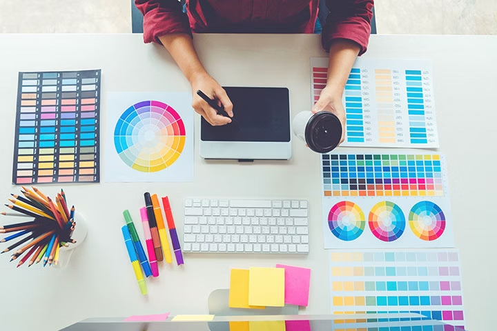 Office desk with colour palettles and a tablet