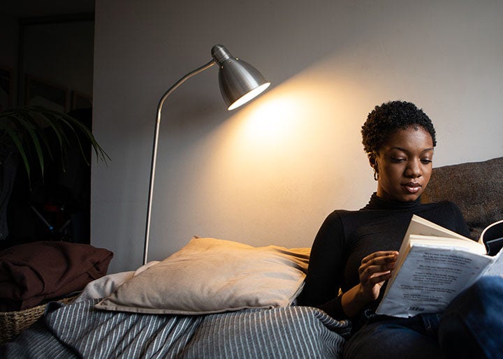 A woman reading a book in bed