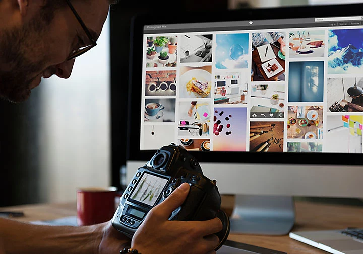 A person examining an image on a digital camera