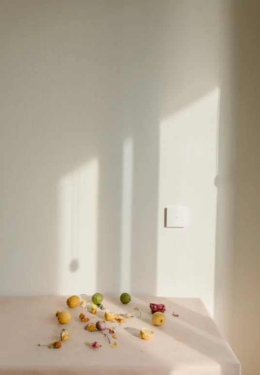 Lemons, limes and flower petals artistically placed on a table