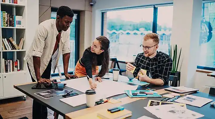 Creative team collaborating around a table with sketches and storyboards